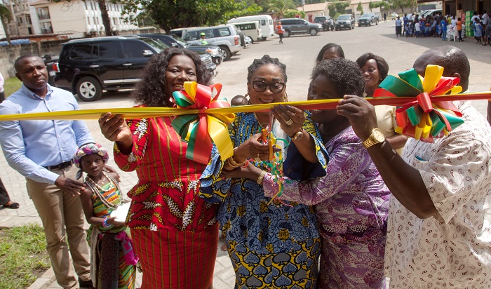 Mrs Lordina Mahama (middle), the First Lady, being assisted by Nana Oye Lithur (left), the Minister of Gender, Children and Social Protection, and Mrs Christiana Addy, the Manageress of the home, to cut the tape to inaugurate the accommodation facility (left) 